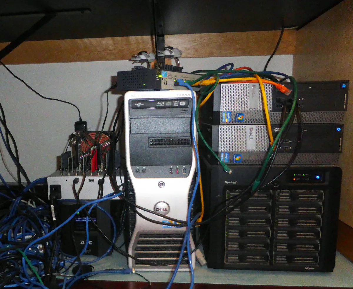 Illustrative image of a desktop computer used as server under a desk with lots of cables